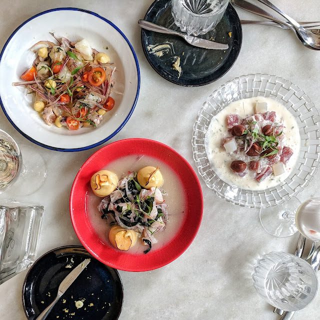 Plates of ceviche on a table at Cevicheria in Lisbon