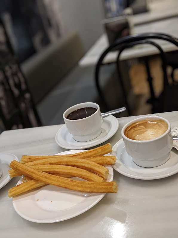 Hot chocolate and churros on a table in Barcelona