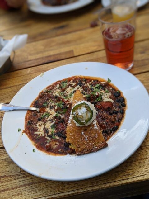 Bowl of elk chili and glass of cider from Wonderland Cafe near Yellowstone