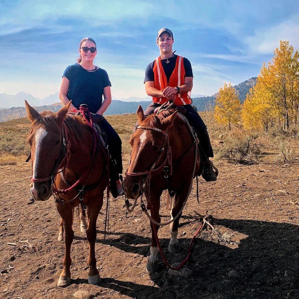 One of the best things to do in Yellowstone - horseback riding. Woman and man on horseback.