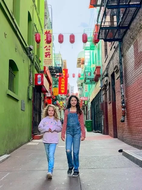 Adventurous Tastes| San Francisco's Chinatown During 4 Days in Northern California with kids these two girls are walking down a Chinatown alleyway in San Francisco