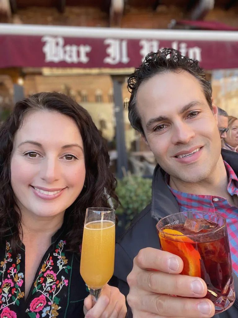 Woman and Man from Adventurous Tastes with cocktails in Siena in Tuscany
