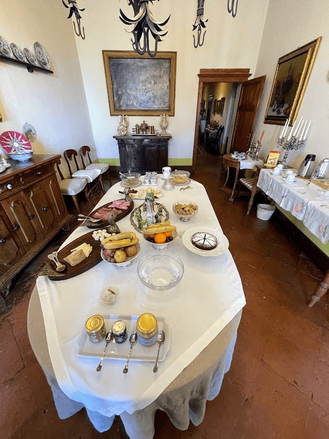 Tuscany hotel in a castle - dining room with a delicious breakfast spread