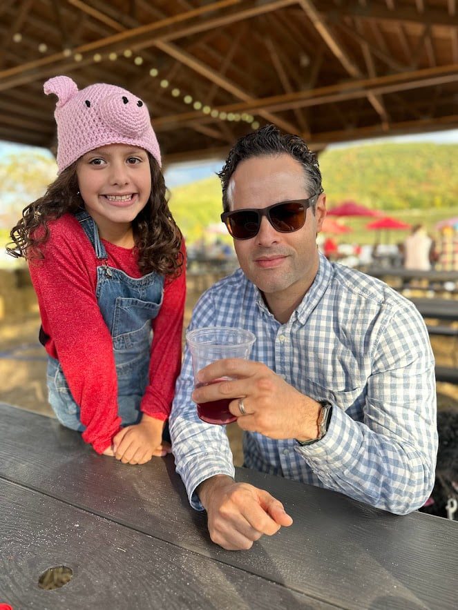 Father and daughter from Adventurous Tastes drinking cider in the Catskills in the fall