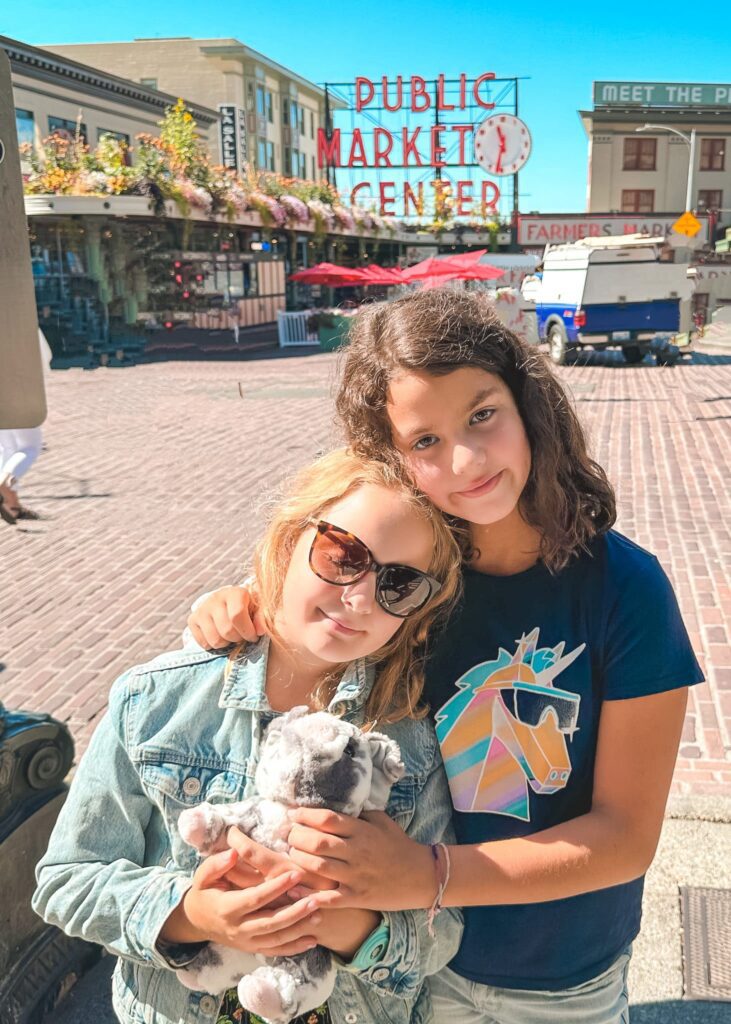 Two young girls from Adventurous Tastes in front of Seattle's Pike Market