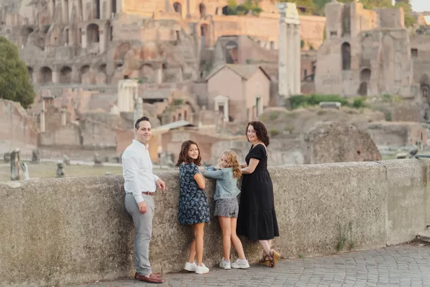 Family portrait taken in front of ruins while in Rome with kids