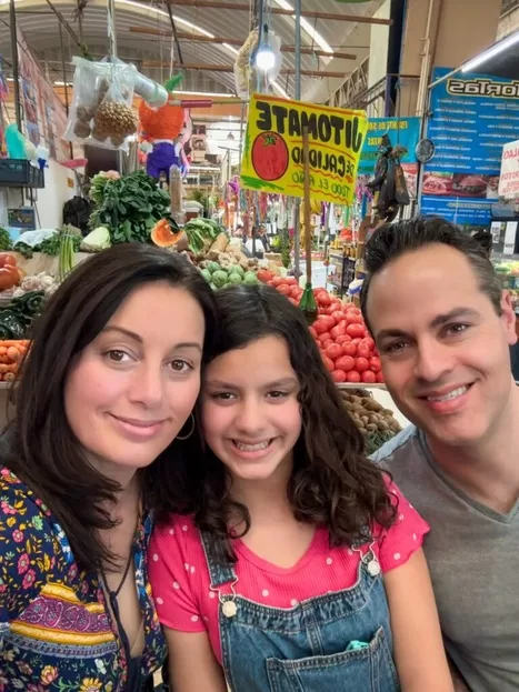 Mother, father and daughter smiling in a Mexico City market | best things to do in Mexico City