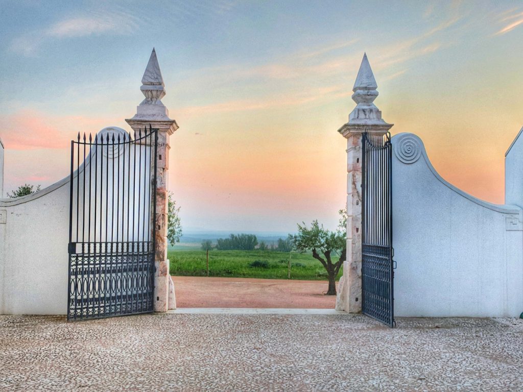 Sunset viewed through the gates at Portugal's beautiful Torre de Palma wine resort in the Alentejo region