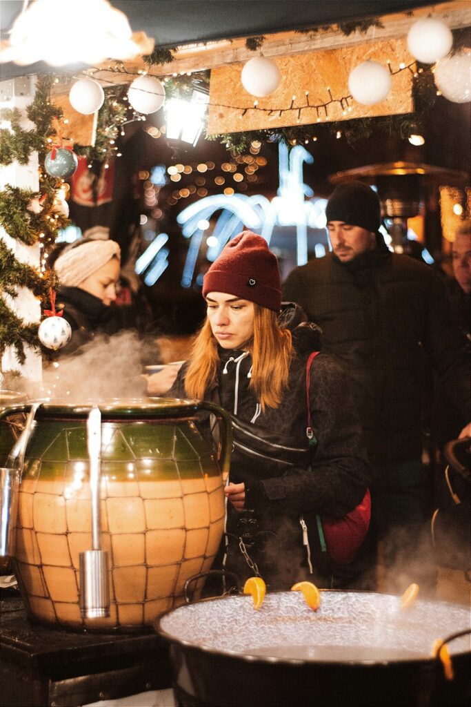 Woman at night enjoying a Budapest Christmas market
