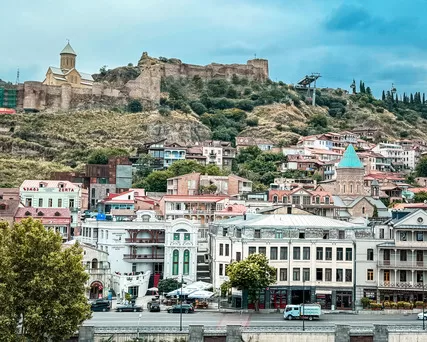 Tbilisi city view and fortress above with blue skies