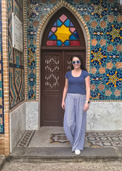 Woman with sunglasses in front of tiled mosaic and doors in Tbilisi, Georgia's sulpher bath district