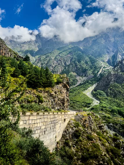 Dramatic mountain views and a winding road seen during Georgia travel near Kazbegi