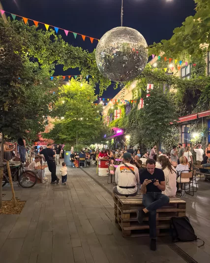 Georgia travel guide - Nighttime couryard of young people socializing and drinking in Tbilisi, Georgia