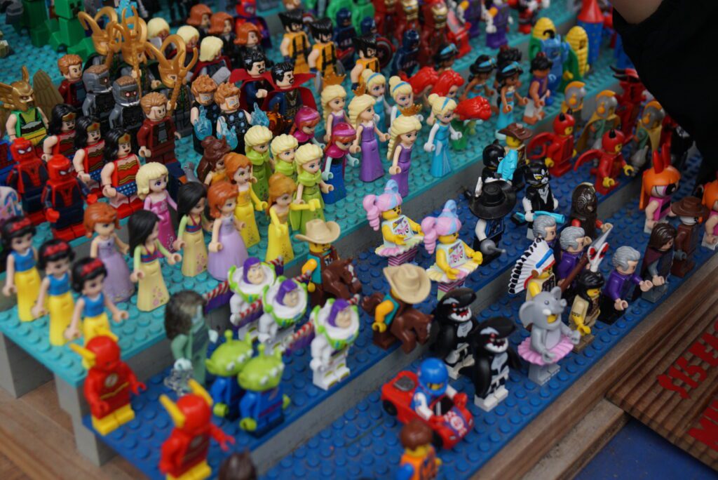 Different lego charactures/figurines on lego stands.