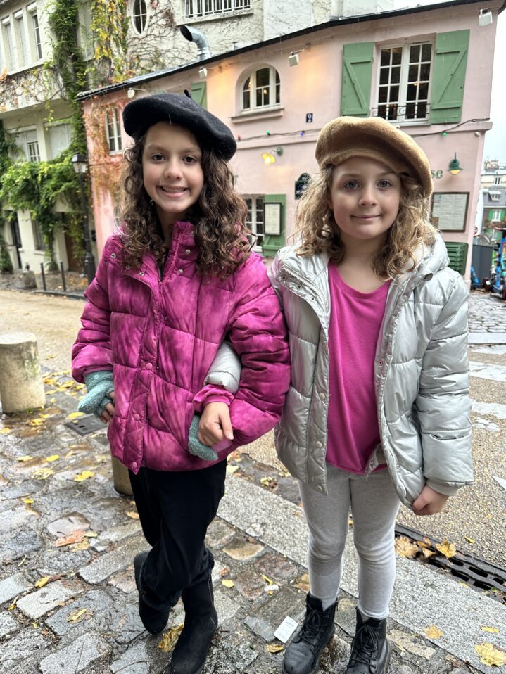 two little girls in winter coats and berets in Paris