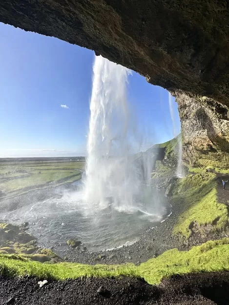 Standing behind a waterfall in Iceland